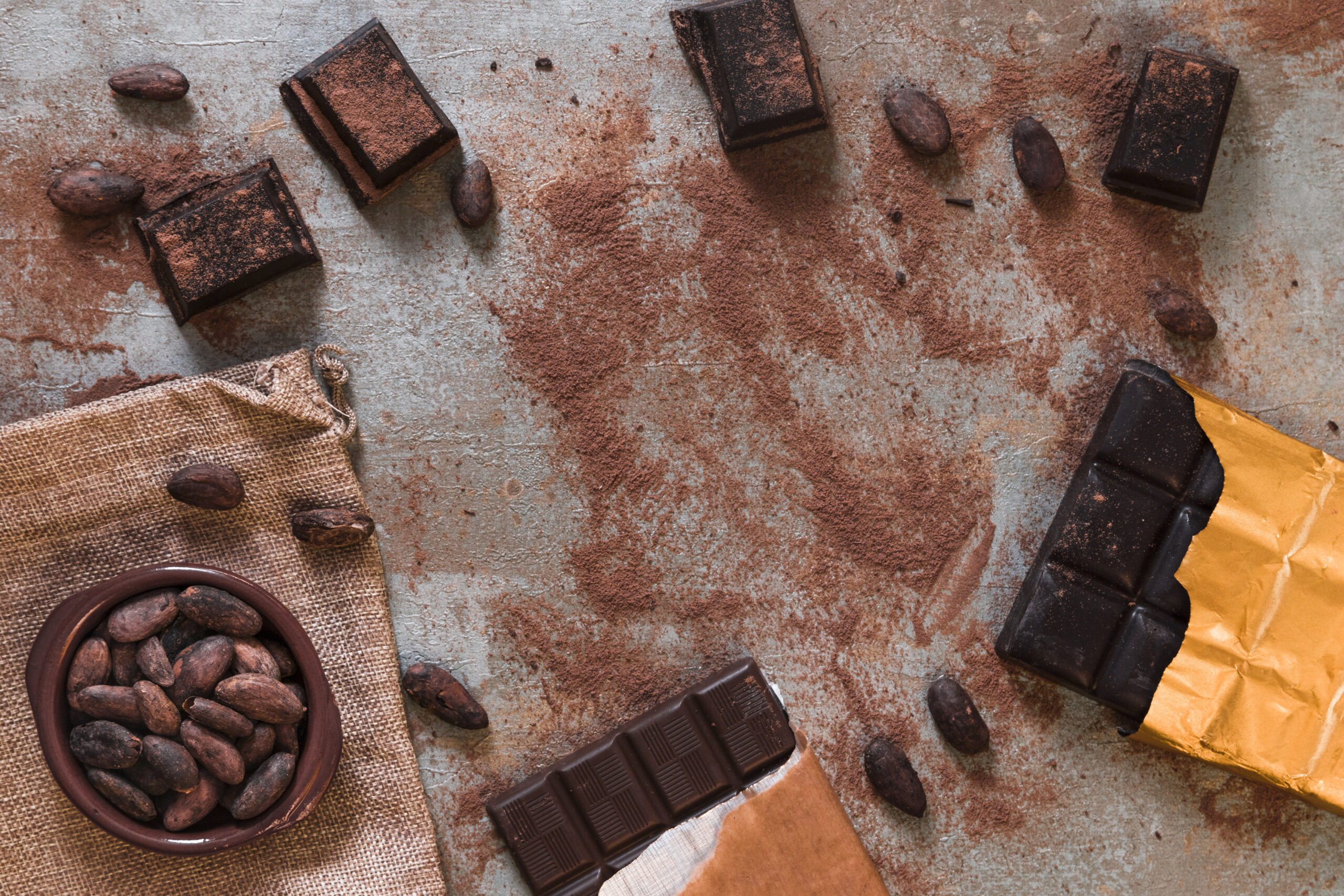 dark-chocolate-bar-with-scattered-cocoa-powder-beans-bowl-scaled.jpg